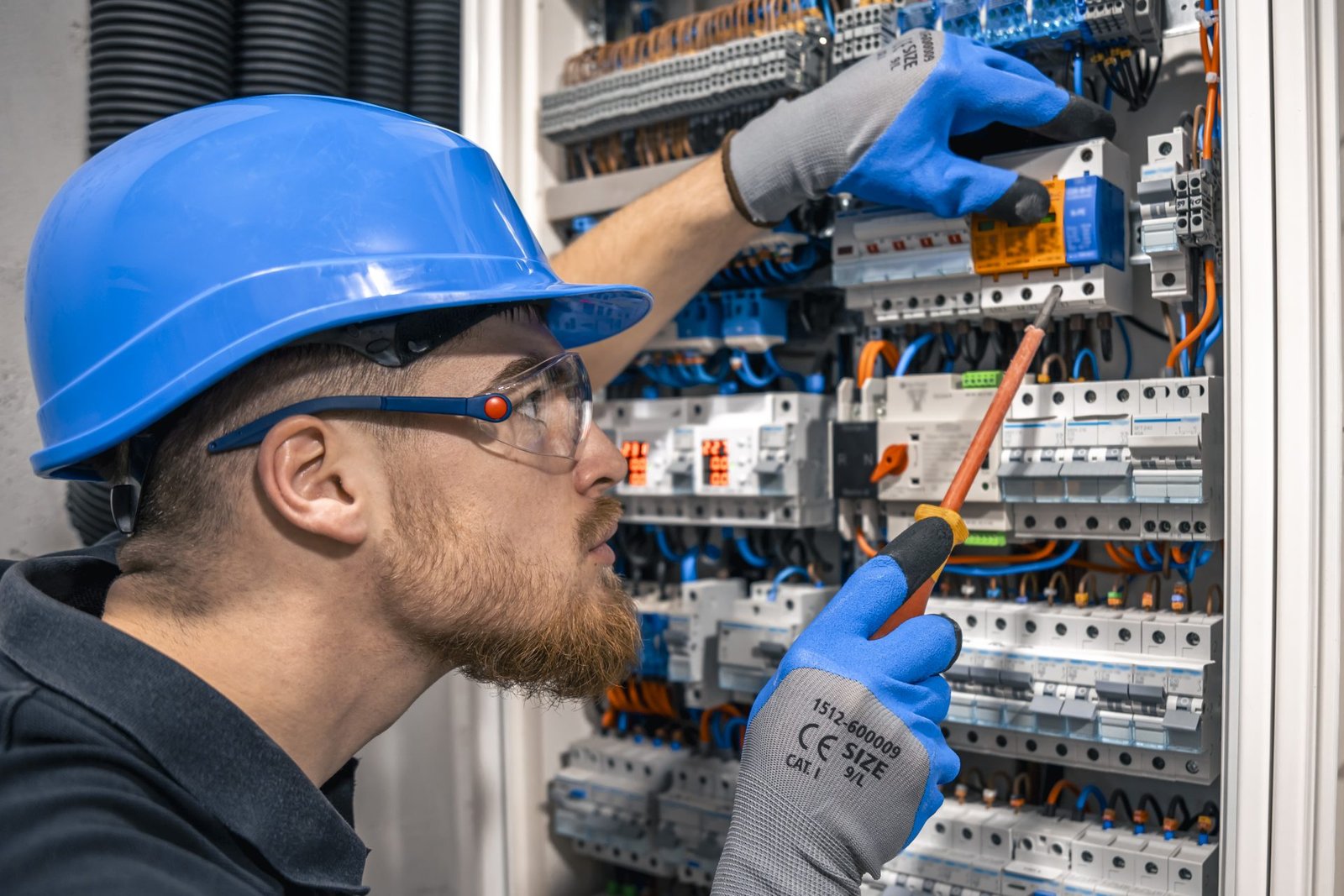 Male Electrician Working Switchboard With Fuses — ProSansaar